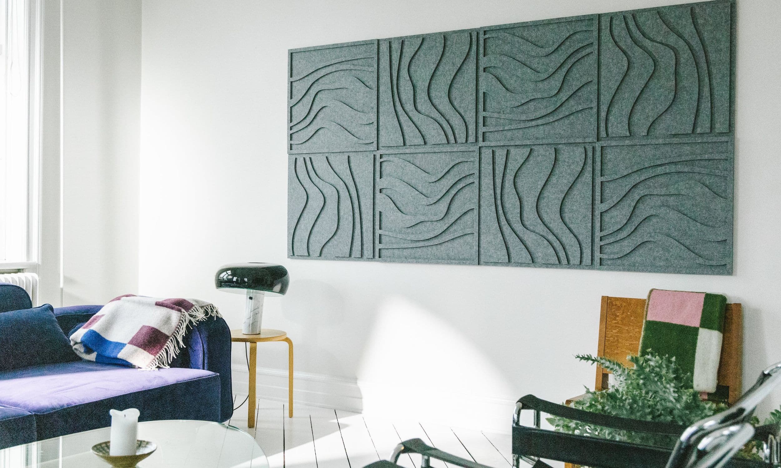 Green acoustic wave panels from Arturel, installed in a modern living room to enhance sound quality and complement the interior design.